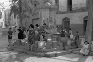 Dones i nens recollint aigua a la font de la plaça del Pou, a Vilanova i la Geltrú